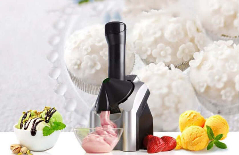 Home ice cream machine with fresh fruit desserts and vanilla cupcakes in the background.