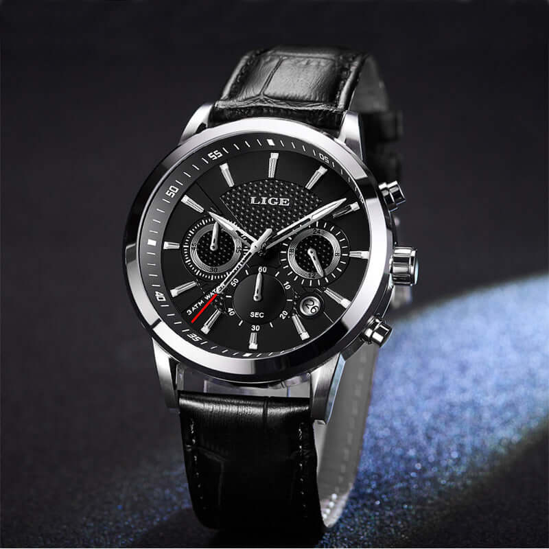 Black quartz men's watch with chronograph features and a sleek leather strap on a dark background.